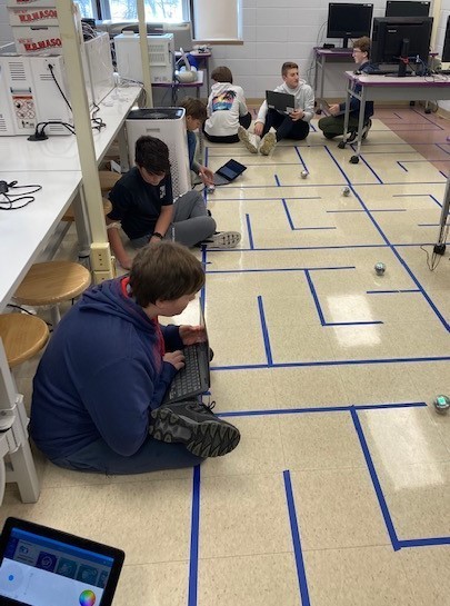 Students with robots on maze