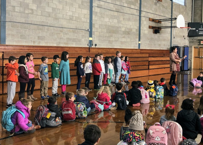 2nd grade singing at School Meeting